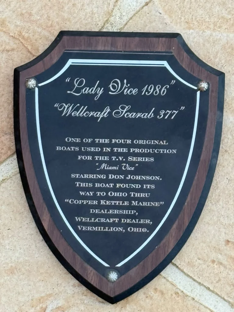 Shield-shaped plaque reading Lady Vice 1986, Wellcraft Scarab 377, one of the four original boats used in the production of Miami Vice