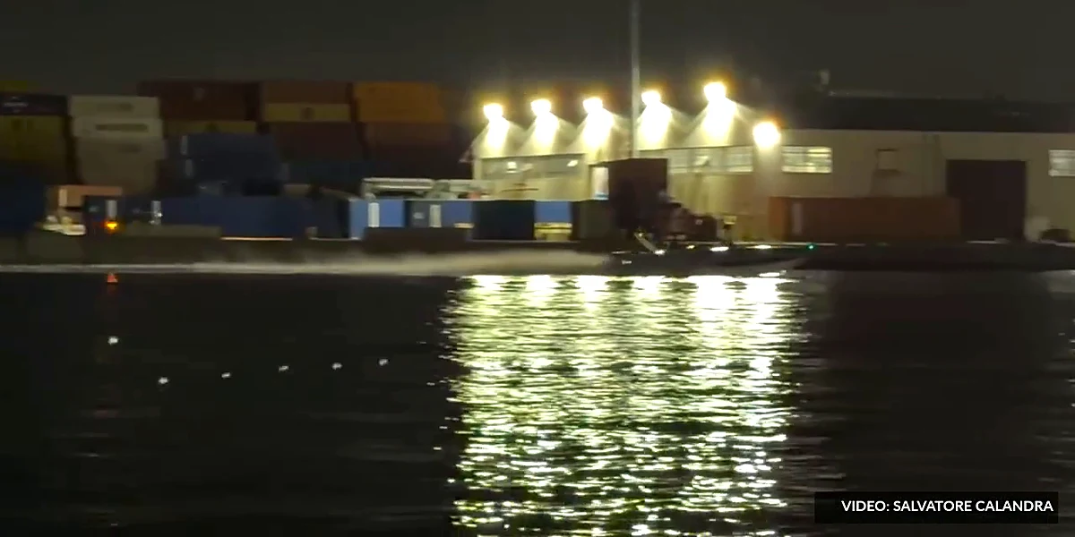 The Wellcraft Scarab Vicious running at speed past a floodlit quay at Port Newark, New Jersey, at night during Miami Vice 85 filming