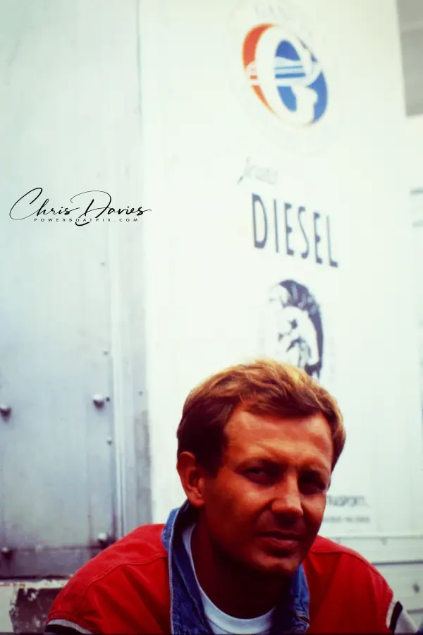 Stefano Casiraghi in a red jacket in front of the Gancia and Diesel team truck, Monaco, October 1990