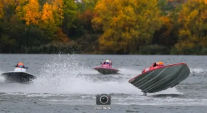 Three GT15 boats racing on Stewartby Lake at the 2026 British Masters finals, with autumn trees behind